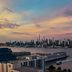 Sheraton Lincoln Harbor Hotel in Weehawken with Hudson River and Manhattan skyline at sunset