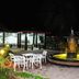 Grand Crown Hotel in Anuradhapura: lit courtyard with fountain and white patio seating at night
