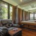 Naiyang Park Resort - Sha Extra Plus spa room in Phuket City with massage table and leather chairs