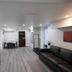 Serene Niagara Inn in Niagara Falls living area with sofa, TV, dining table and kitchenette