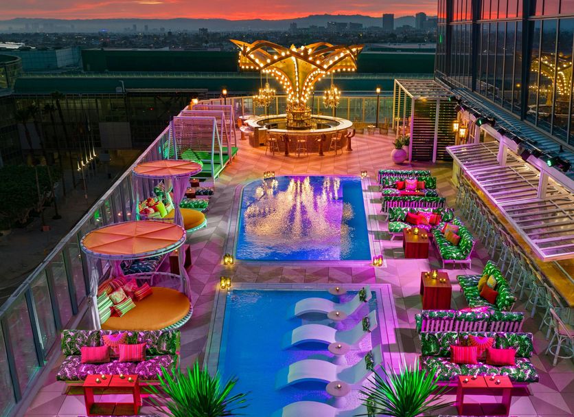 AC Hotels by Marriott Los Downtown Los Angeles rooftop pool at sunset with city skyline views