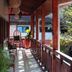 Vila Atlantica Inn in Camburi: covered balcony corridor with chairs, plants and hanging wicker swing seat