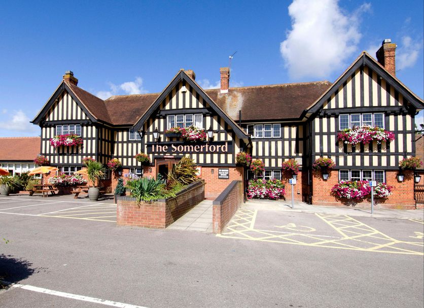 Premier Inn Christchurch - East hotel exterior in Christchurch with Tudor-style facade and flower baskets