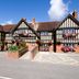 Premier Inn Christchurch - East hotel exterior in Christchurch with Tudor-style facade and flower baskets