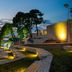 D-Resort Sibenik in Šibenik with a lit waterfront terrace, sea view, and sunset sky