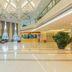 Yichang Guobin Bandao Hotel lobby in Yichang with tall windows, high ceiling, and seating area