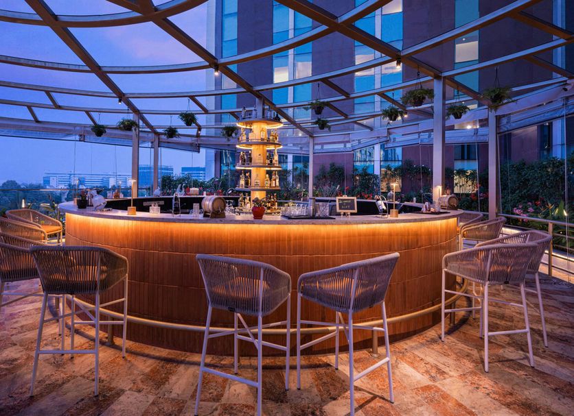 Aloft Bengaluru Outer Ring Road rooftop bar with circular counter and city views in Bengaluru