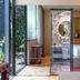 Ignacia Guest House, Mexico City: bright guest room with open balcony doors and marble bathroom vanity