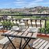 Villa Ambra B&B in Noto balcony with table, chairs and city view over historic rooftops