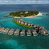 Milaidhoo Maldives in Kamadhoo, aerial view of overwater villas around a turquoise lagoon and island