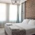 Luna Boutique Hotel Antalya guest room with king bed, brick accent wall and window seating
