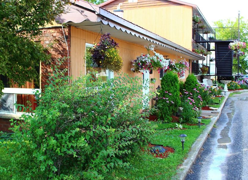 Hawberry Motel in Little Current with a landscaped garden along a wet driveway