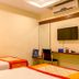 OYO 1594 Hotel Landmark, Visakhapatnam: twin beds, wall-mounted TV and desk in a simple guest room