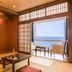 Ooedo Onsen Monogatari Kaike in Yonago: tatami room with ocean-view balcony and seating