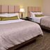 Candlewood Suites Morgantown-Univ West Virginia guest room with two queen beds and bedside lamp