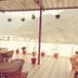 Hotel Vishla Palace in Rishikesh rooftop terrace with tables, chairs, and mountain views