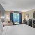 Best Western Porterville Inn room with king bed, sofa, TV, and window view in Porterville