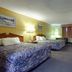 Americas Best Value Inn & Suites Senatobia room with two beds, TV, desk and window