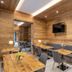Th Cadore - Hotel Antelao dining area in Borca di Cadore with wooden tables, bench seating, and wall TV
