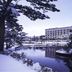 Kagamigaike Hekizantei in Nihonmatsu, overlooking a snowy pond with a reflected hotel building