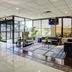 Lobby seating area at Capital O Duncanville Tx in Duncanville with large windows and potted plants