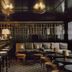 Château Voltaire Paris lounge bar with stools, sofas, and warm brass lighting