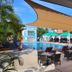 Hotel Santa Cruz Huatulco in Santa Maria Huatulco with outdoor poolside seating and shaded lounge area