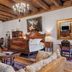 Orlowska Townhouse Apartments, Krakow: ornate bedroom with carved wooden bed, chandelier, rugs and sofa