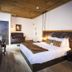 La Casa del Camino, Laguna Beach: rustic guest room with king bed, hanging lights, wood ceiling and seating area