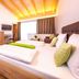 Hotel-Restaurant Lampenhäusl in Fusch an der Grossglocknerstrasse: bright guest room with wood ceiling and double bed