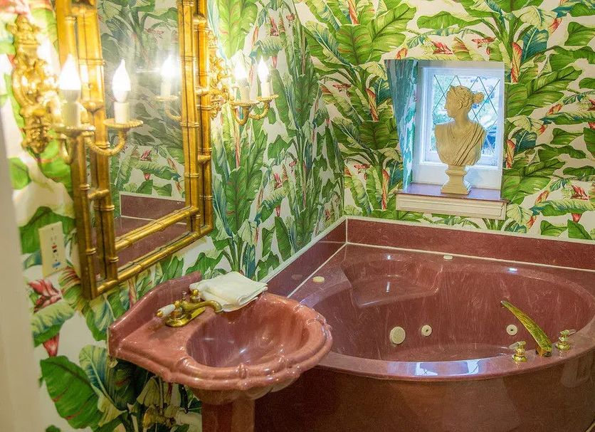 Fairfield Manor Bed and Breakfast in Shreveport bathroom with jetted tub, sink and tropical wallpaper