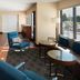 Towneplace Suites By Marriott Danville lobby seating area with large windows and blue chairs