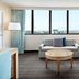 Embassy Suites by Hilton Tampa Airport Westshore in Tampa living room with city-view windows
