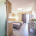 Oasis Tigaki room with twin beds, balcony door, and walk-in shower in Tigaki