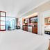Jet Luxury Resorts @ The Signature Condo Hotel Las Vegas suite with bed, kitchenette, and city view