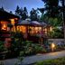 Tigh-Na-Mara Seaside Spa Resort in Parksville at dusk, with lit cabins beside a winding path and trees