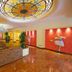 Mercure Reggio Emilia Centro Astoria lobby with stained-glass ceiling, chandeliers and seating area