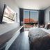 Spice House Chiang Mai guest room with king bed, wall-mounted TV, and balcony city view