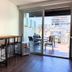 CH Recoleta Suites in Buenos Aires: modern room with bar seating and balcony overlooking city buildings