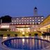 Akiu Resort Hotel Crescent in Sendai at dusk, with lit facade, circular pool, and manicured lawn