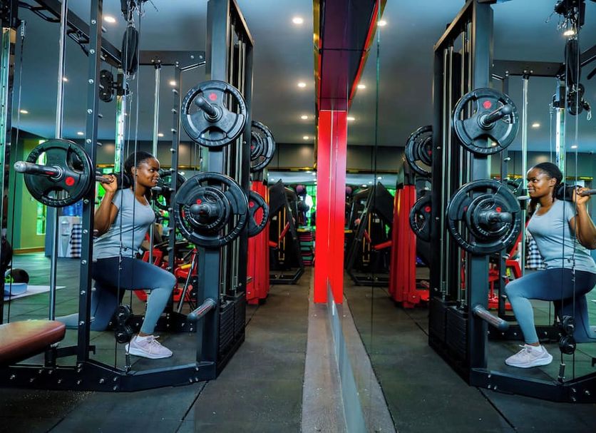 Green Mountain Hotel Arusha gym with dual cable machines and mirrored workout area
