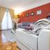 Apartments with Pool Villa Rossella 1 in Rovinj living room with sofa, TV, rug and balcony curtains