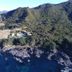 Lottin Point Motel in Hicks Bay overlooking a rugged coastline and deep blue ocean from a hillside