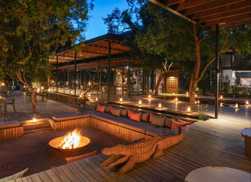 Lion Sands River Lodge in Sabie Park: outdoor fire pit lounge and candlelit deck at dusk