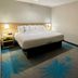 Days Inn by Wyndham Jefferson City guest room with king bed, bedside lamps, and window air conditioner