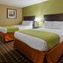 SureStay by Best Western Lenoir City hotel room with two double beds and bedside lamp