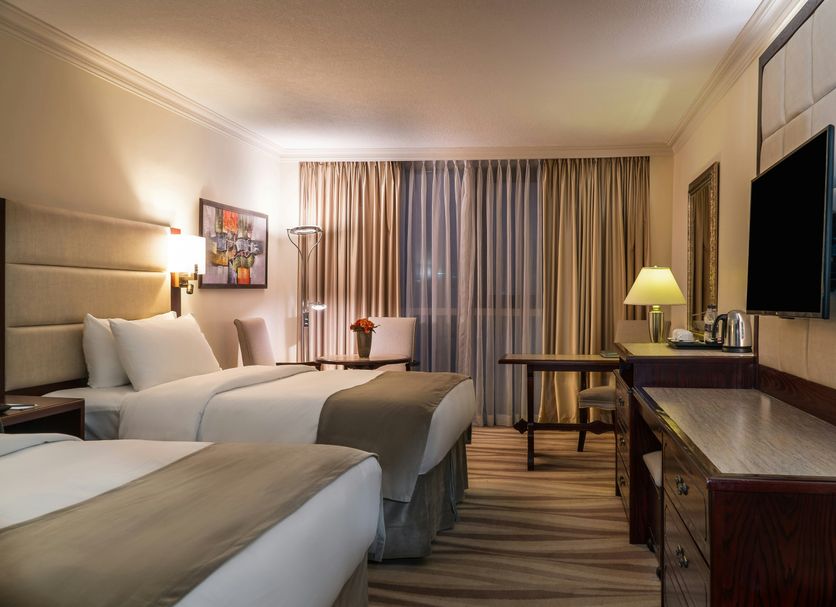 Landmark Amman Hotel & Conference Center in Amman, twin beds and TV in a guest room
