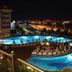Adalya Art Side in Side: illuminated outdoor pool and terrace with city lights at night