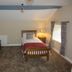 The Kings Head in Meifod guest room with two single beds, bedside lamp, and carpeted floor