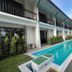 Radateeree Boutique Resort in Chiang Mai with long outdoor pool beside two-story guest rooms